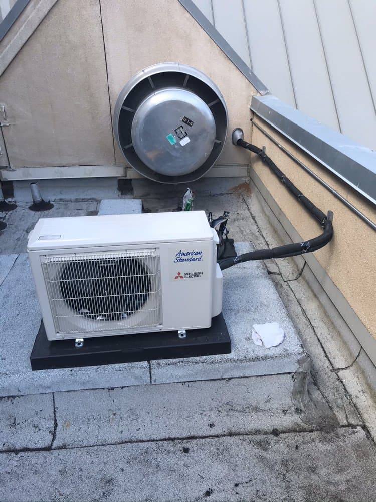 Mitsubishi mini-split condenser installed by Dickinson Heating & Air Conditioning — a real local job